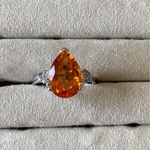 Simulated teardrop stone with crystals